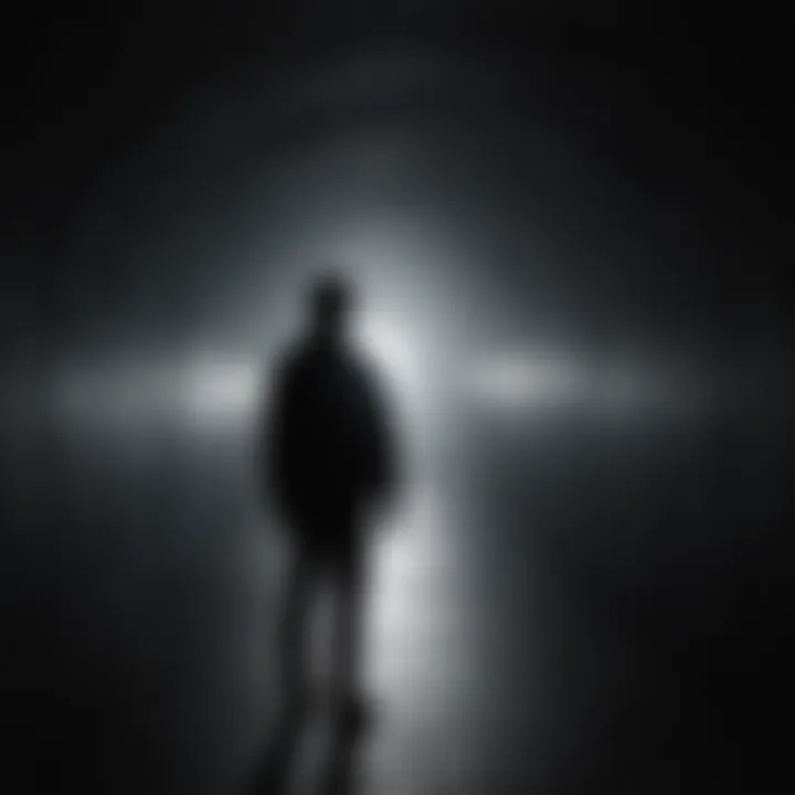 Silhouette of person standing under a beam of light in a dark tunnel